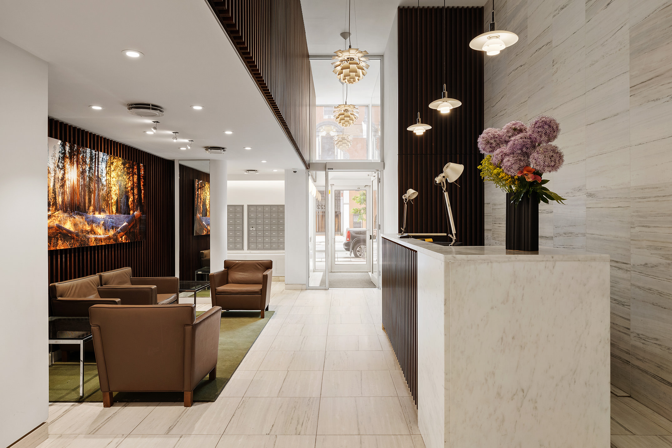 222 West 14th Street, Unit 3N Manhattan, NY 10011 - Photo 7 of 9 a lobby with furniture and potted plants