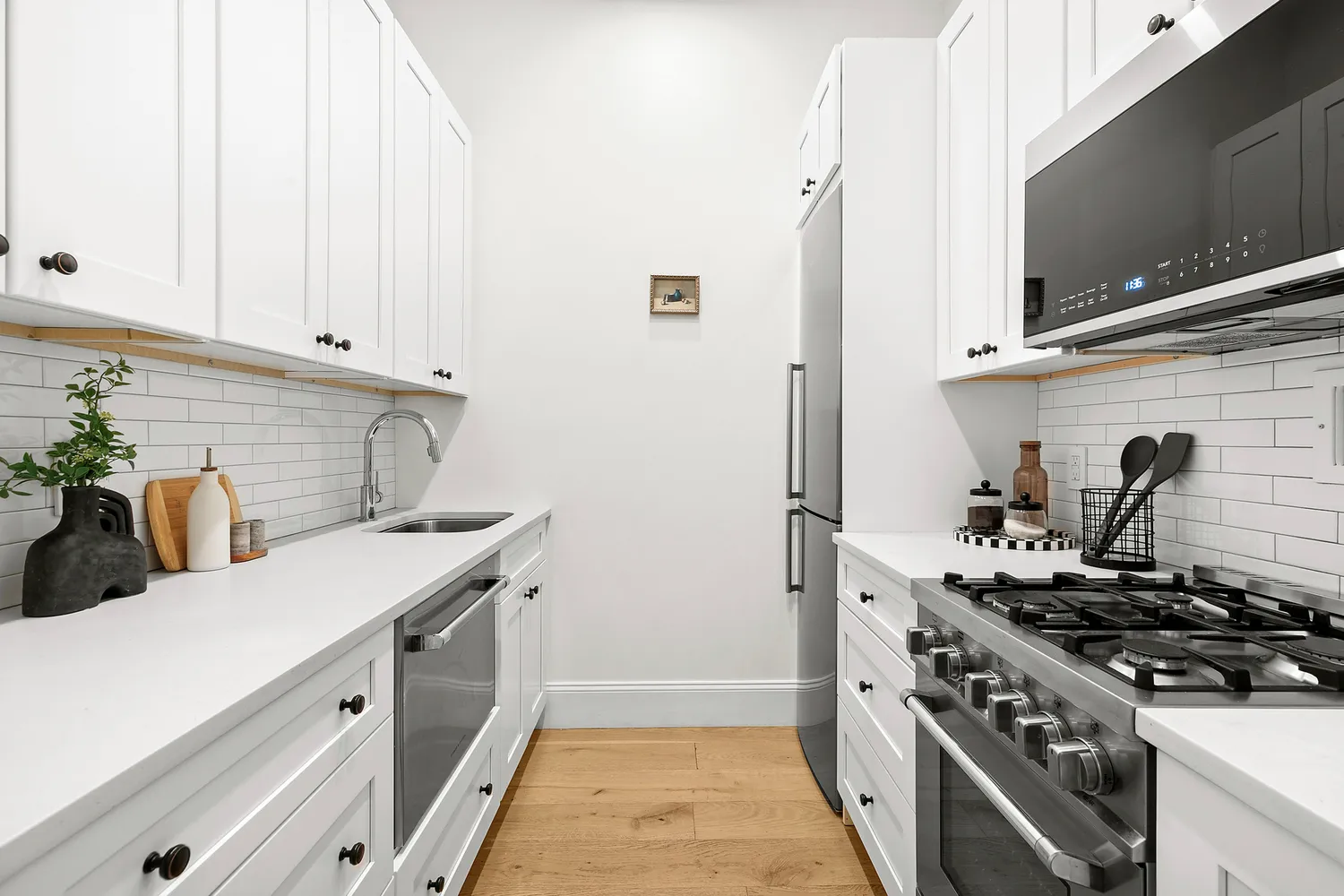 a kitchen with stainless steel appliances a stove and a microwave