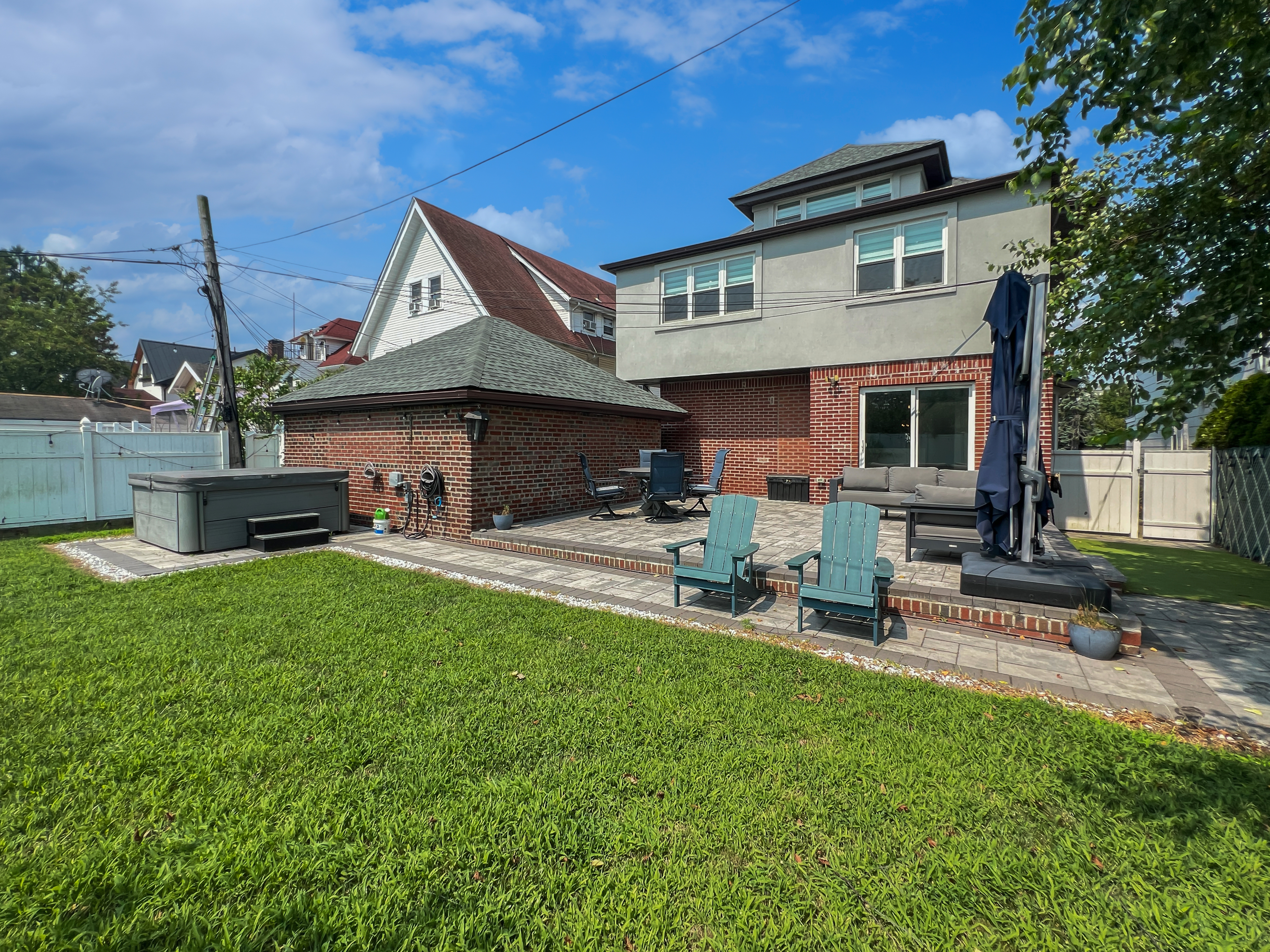 5021 Surf Avenue Brooklyn, NY 11224 - Photo 23 of 32 a backyard of a house with table and chairs
