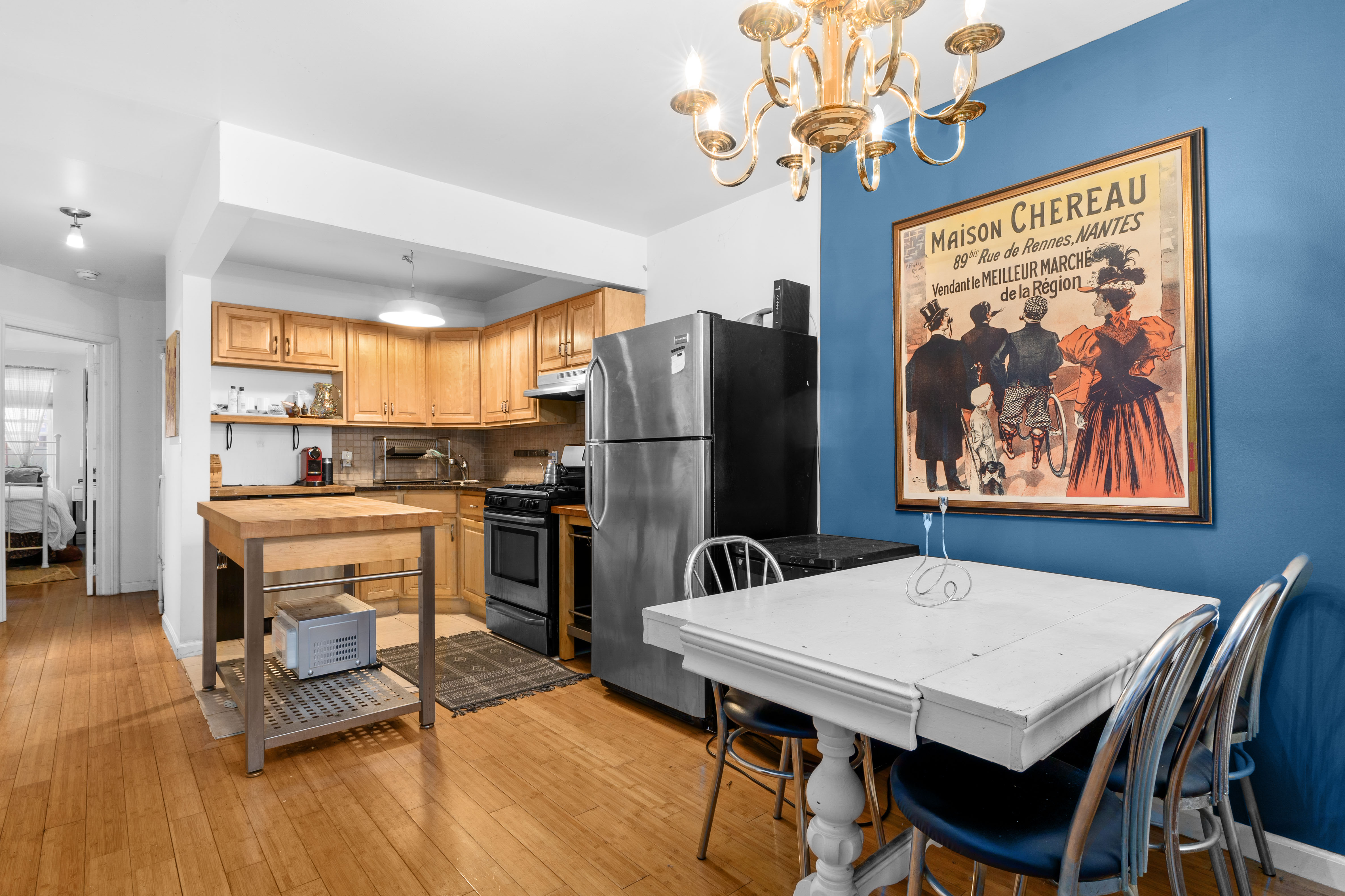 547 Gates Avenue, Unit 1 Brooklyn, NY 11216 - Photo 1 of 7 a view of a dining room with furniture wooden floor and a chandelier