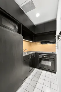a kitchen with a sink a stove and cabinets