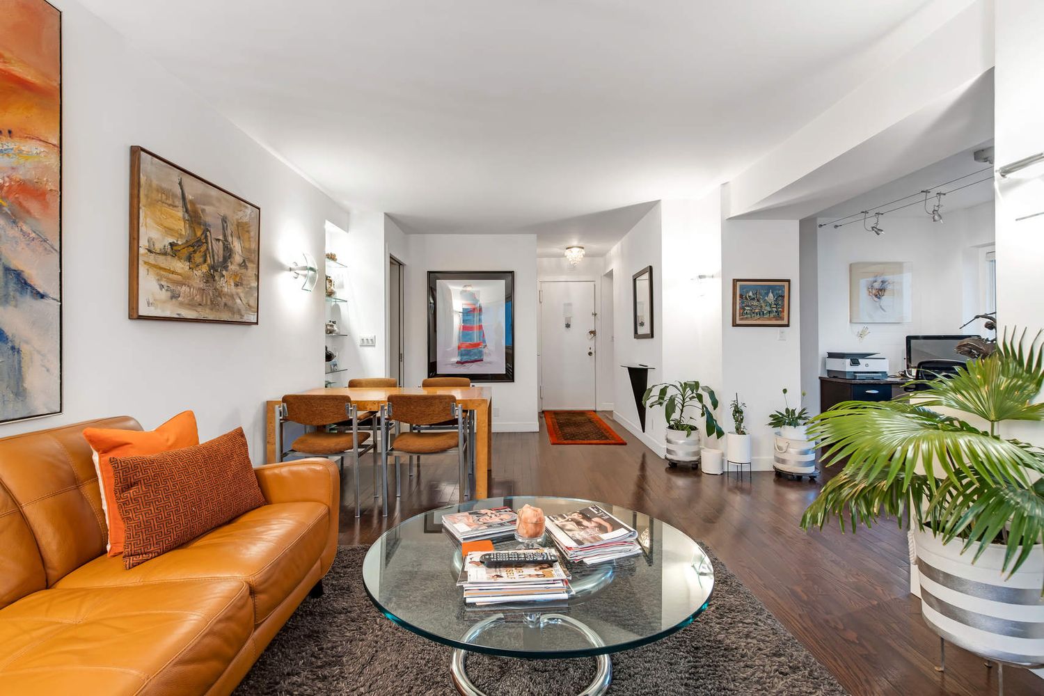 520 East 76th Street, Unit PHC Manhattan, NY 10021 - Photo 6 of 15 a living room with furniture potted plant and a wooden floor