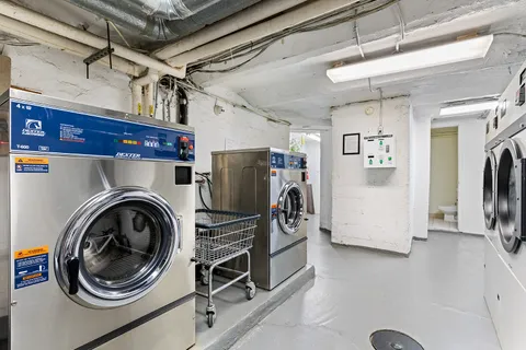 a view of a storage & utility room with refrigerator