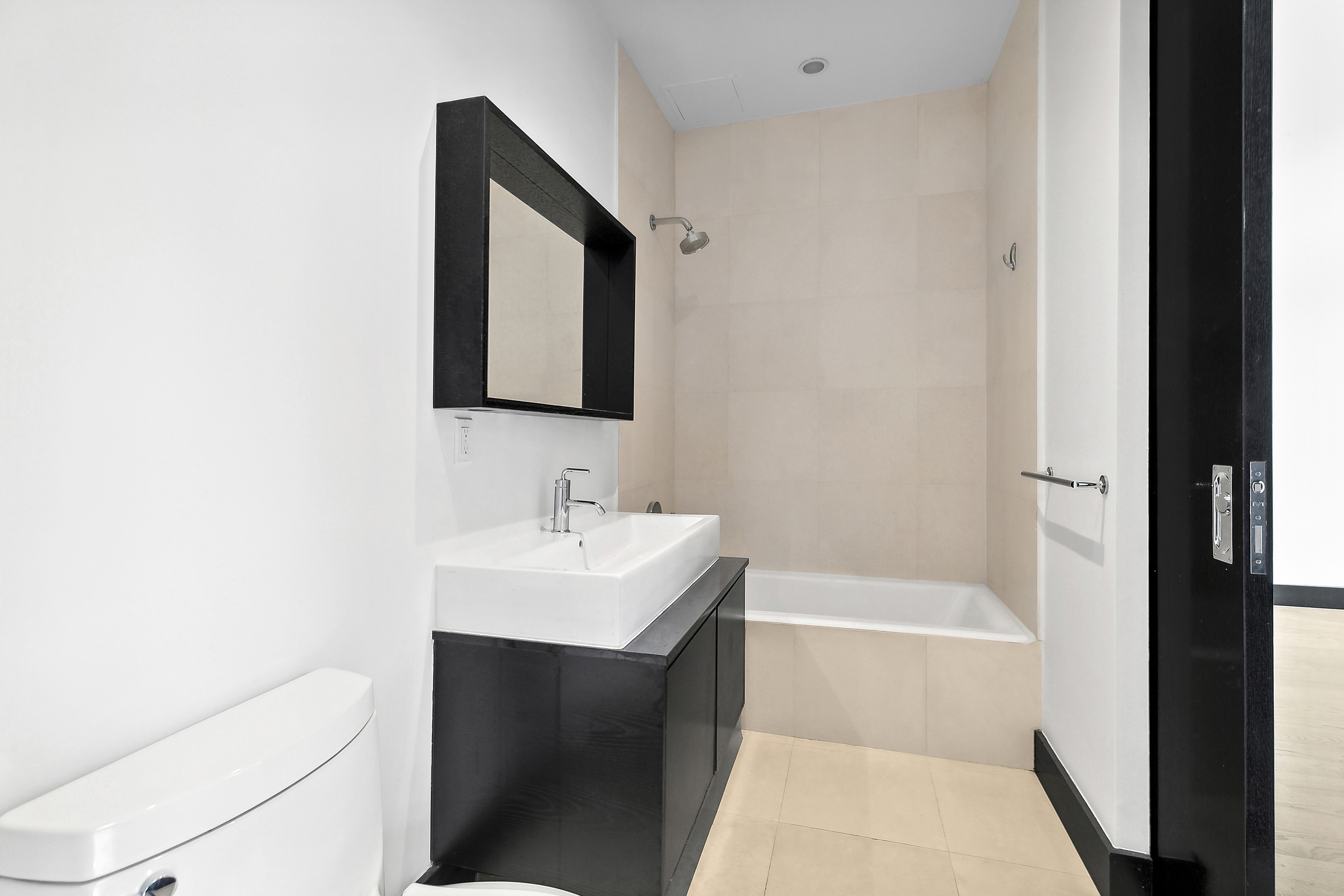 254 Park Avenue South, Unit 3C Manhattan, NY 10010 - Photo 8 of 9 a bathroom with a sink a toilet and shower