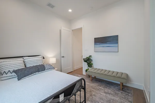 a room with a couch and a potted plant