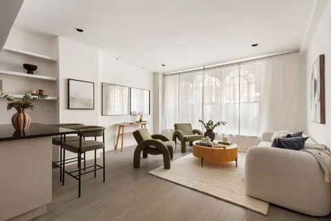 a living room with furniture and large windows