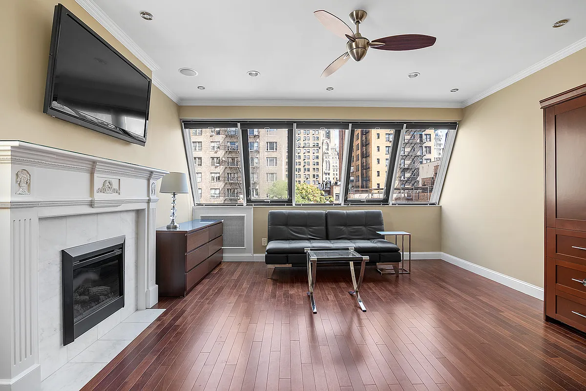 258 West 71st Street, Unit 3A Manhattan, NY 10023 - Photo 1 of 8 a living room with furniture fireplace and flat screen tv