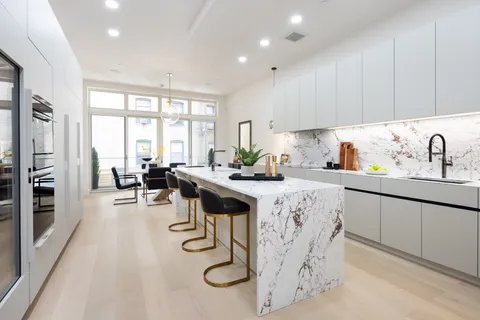 a kitchen with counter top space a sink cabinets and appliances