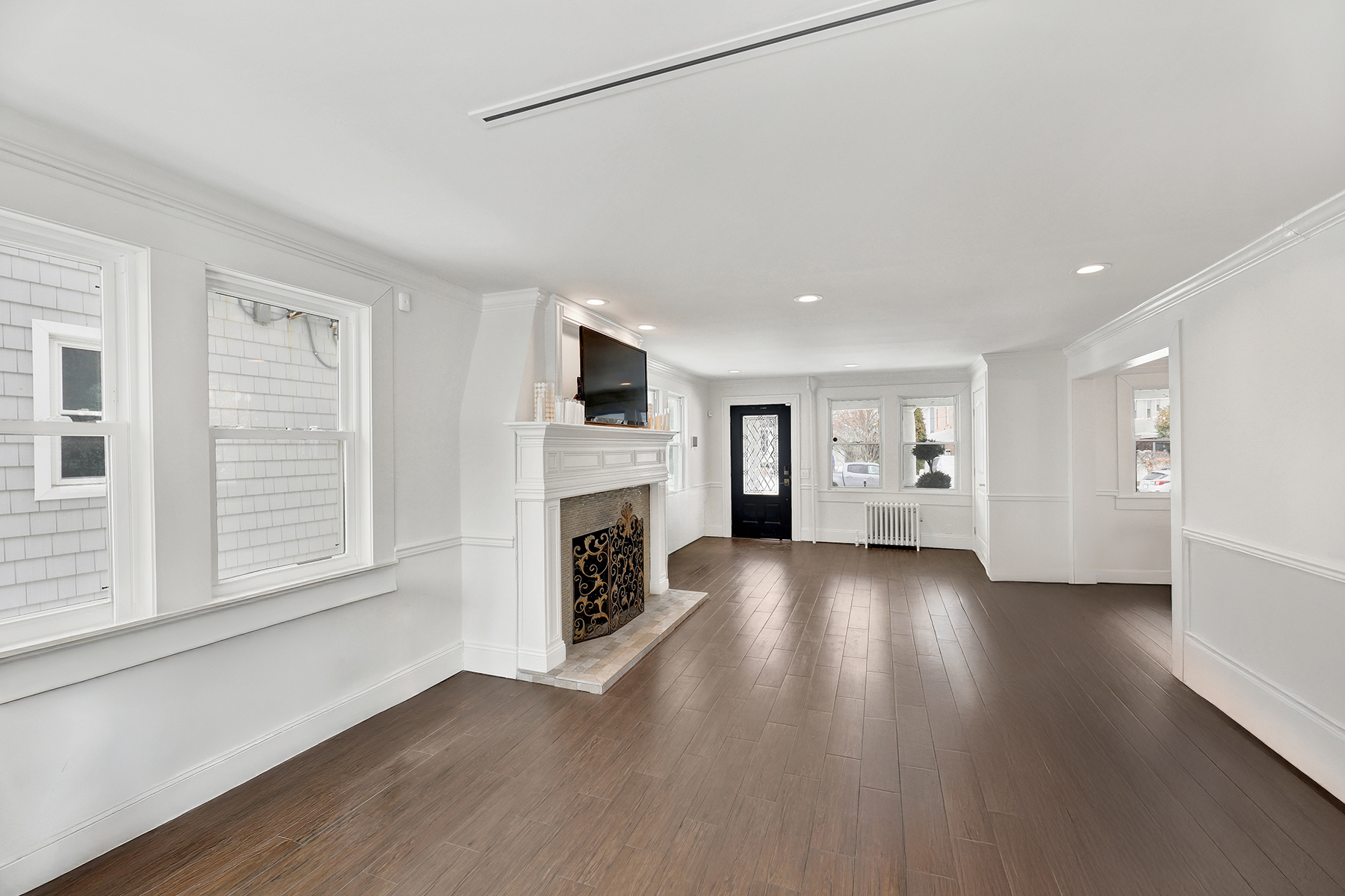 334 Beach 146th Street Queens, NY 11694 - Photo 6 of 21 a view of empty room with wooden floor and fireplace