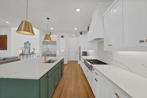 a kitchen with counter top a sink a stove and refrigerator