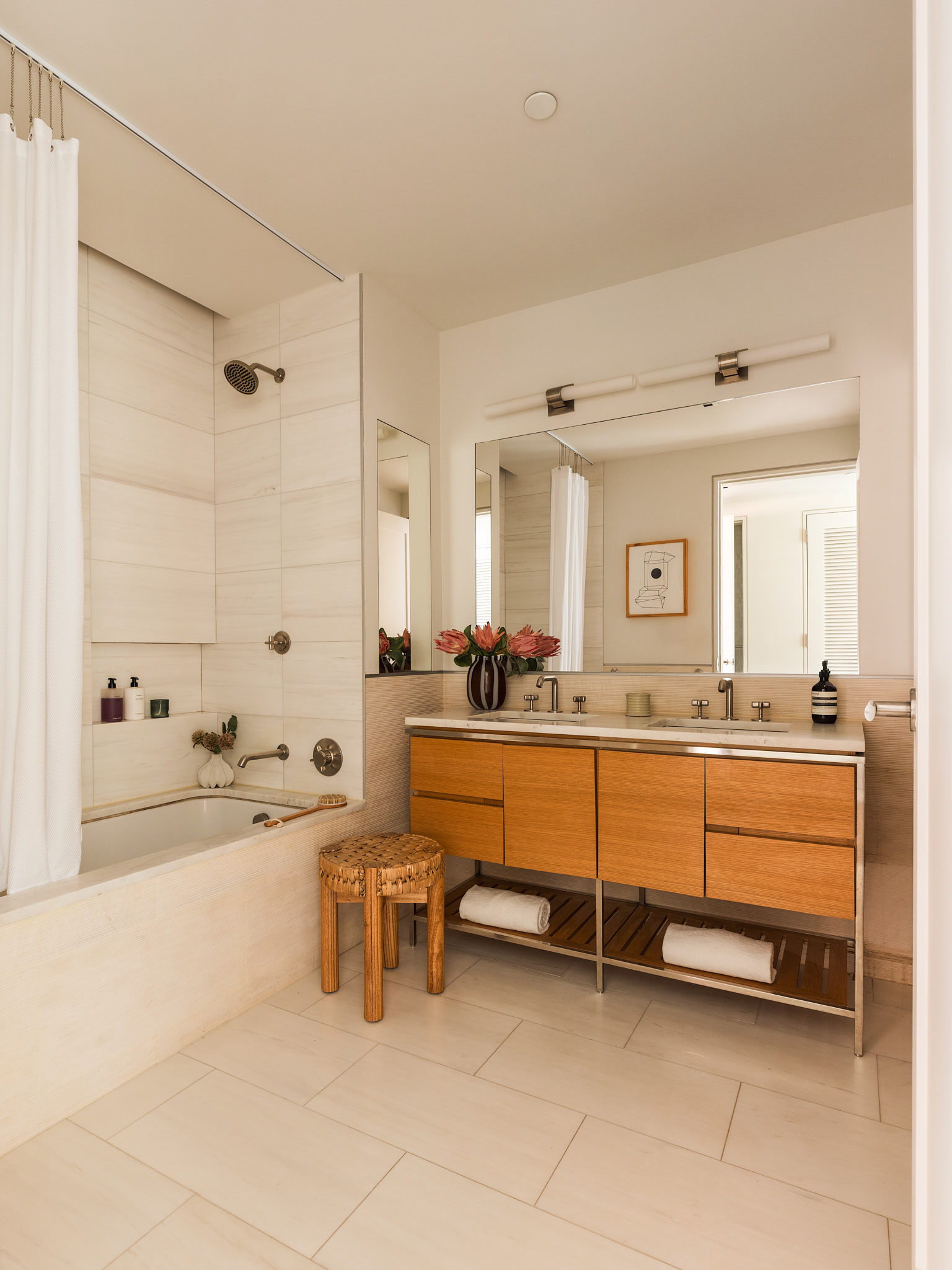 34 Prince Street, Unit 3B Manhattan, NY 10012 - Photo 11 of 18 a spacious bathroom with a double vanity sink a mirror and a bathtub