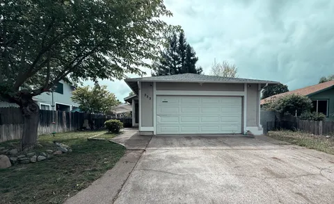 a view of a house with a yard and garage