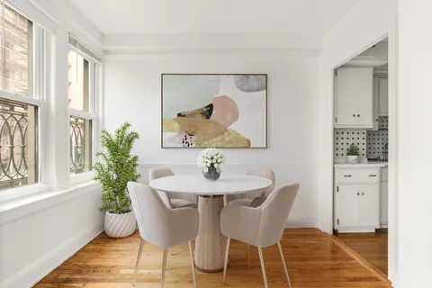 a dining room with furniture and wooden floor