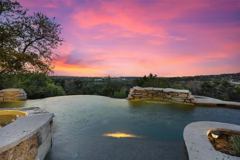 an aerial view of residential houses with outdoor space and trees