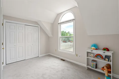 an empty room with baby toys and a window