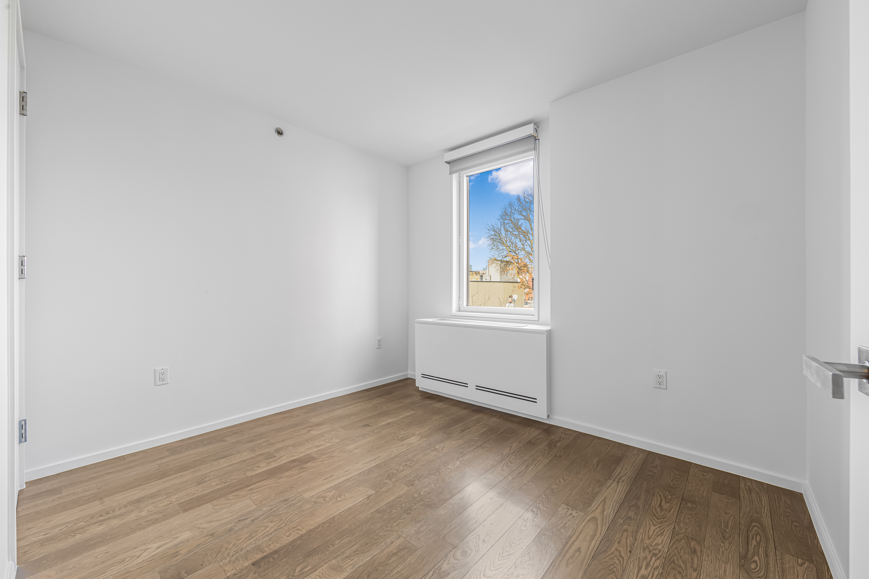 202 8th Street, Unit 4E Brooklyn, NY 11215 - Photo 10 of 19 an empty room with wooden floor and windows
