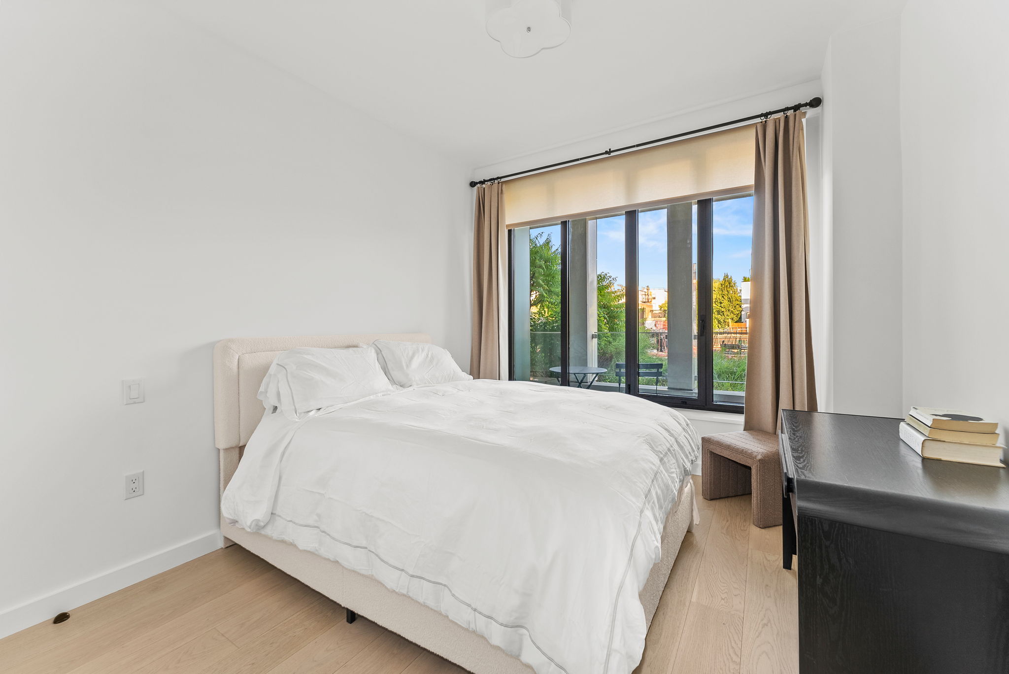 58 St Marks Place, Unit 206 Brooklyn, NY 11217 - Photo 5 of 27 a large bed sitting in a bedroom next to a window