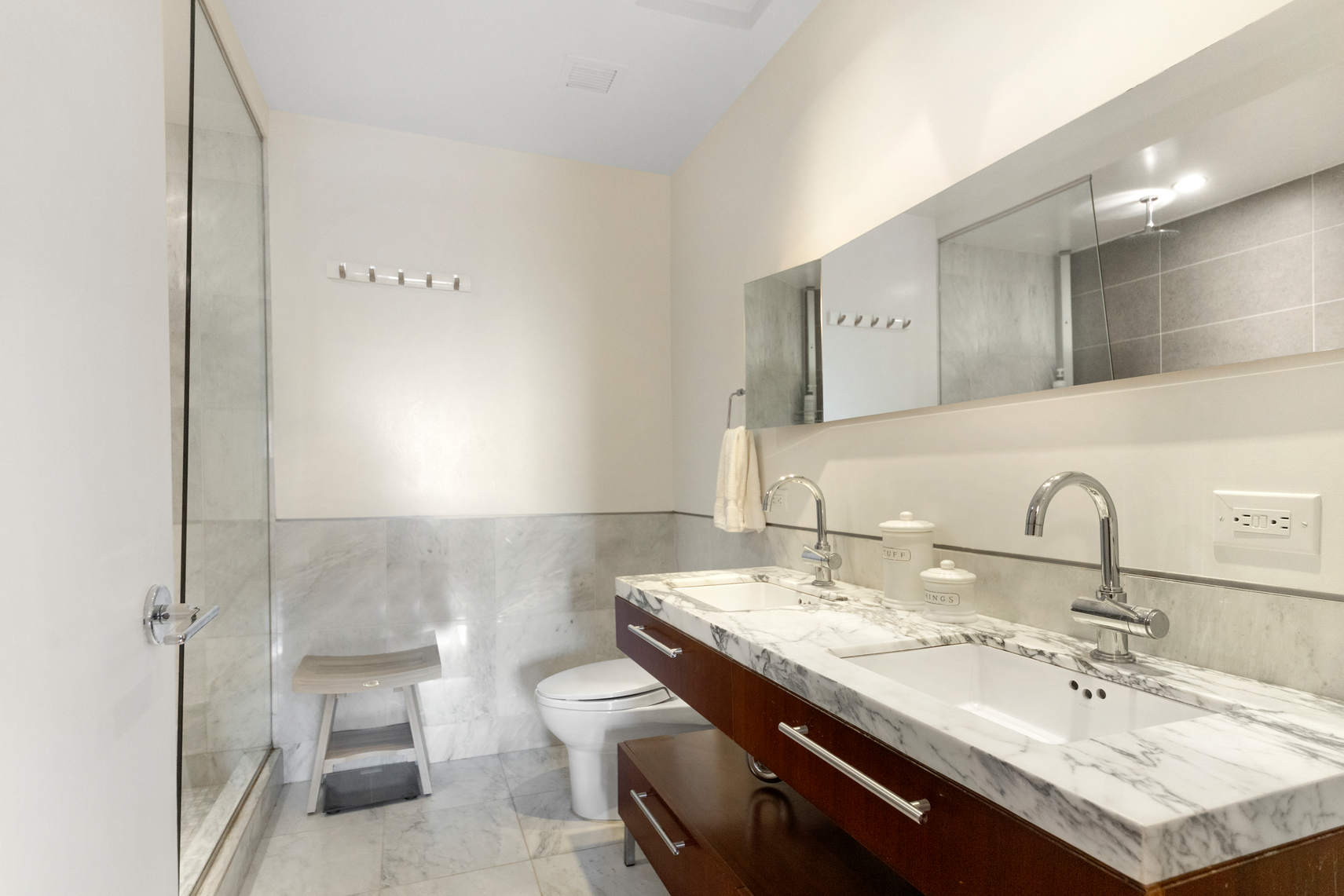 2-17 51st Avenue, Unit 606 Queens, NY 11101 - Photo 9 of 18 a bathroom with a sink and a mirror