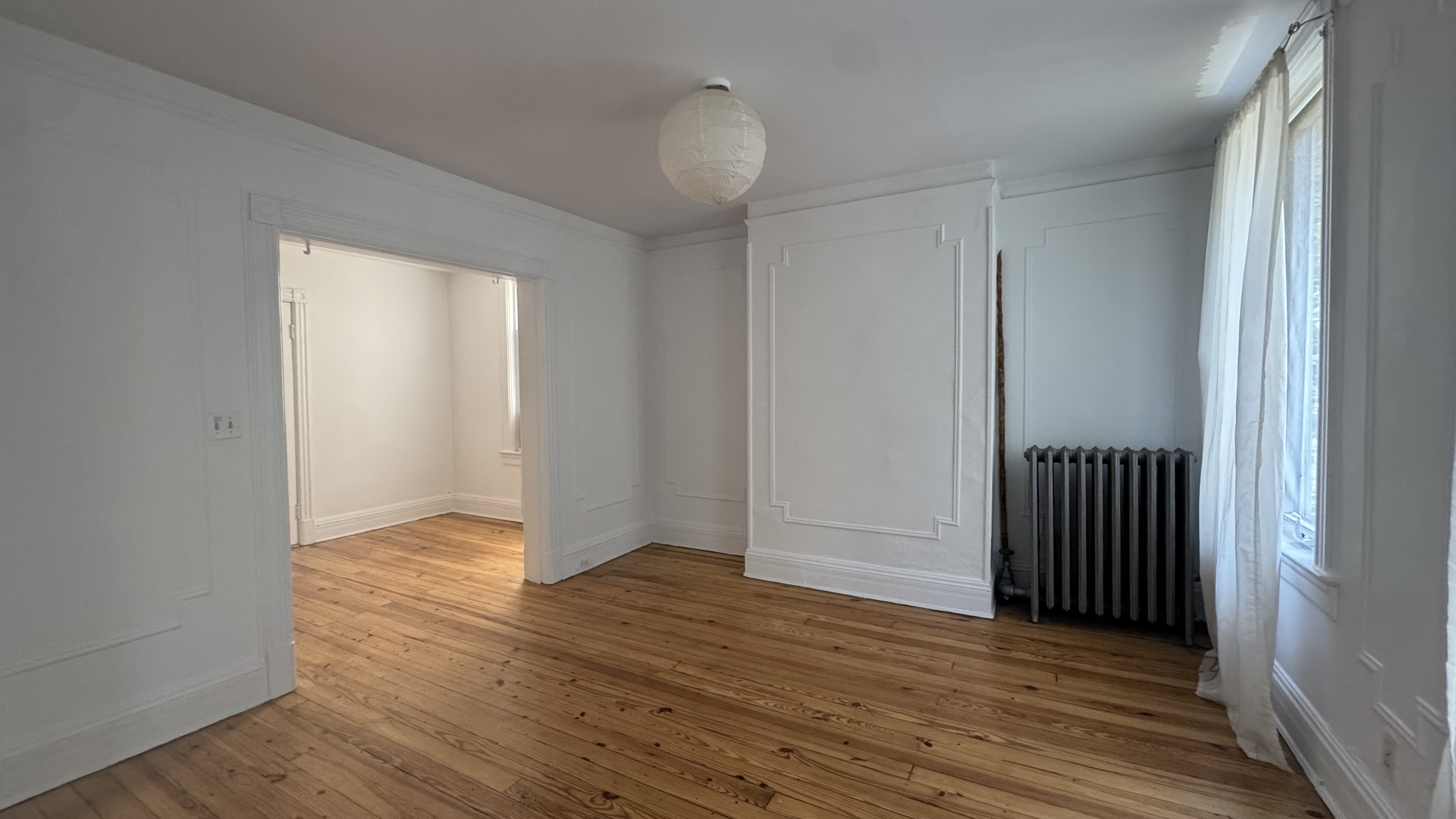196 Seeley Street, Unit 2 Brooklyn, NY 11218 - Photo 4 of 7 an empty room with wooden floor and closet