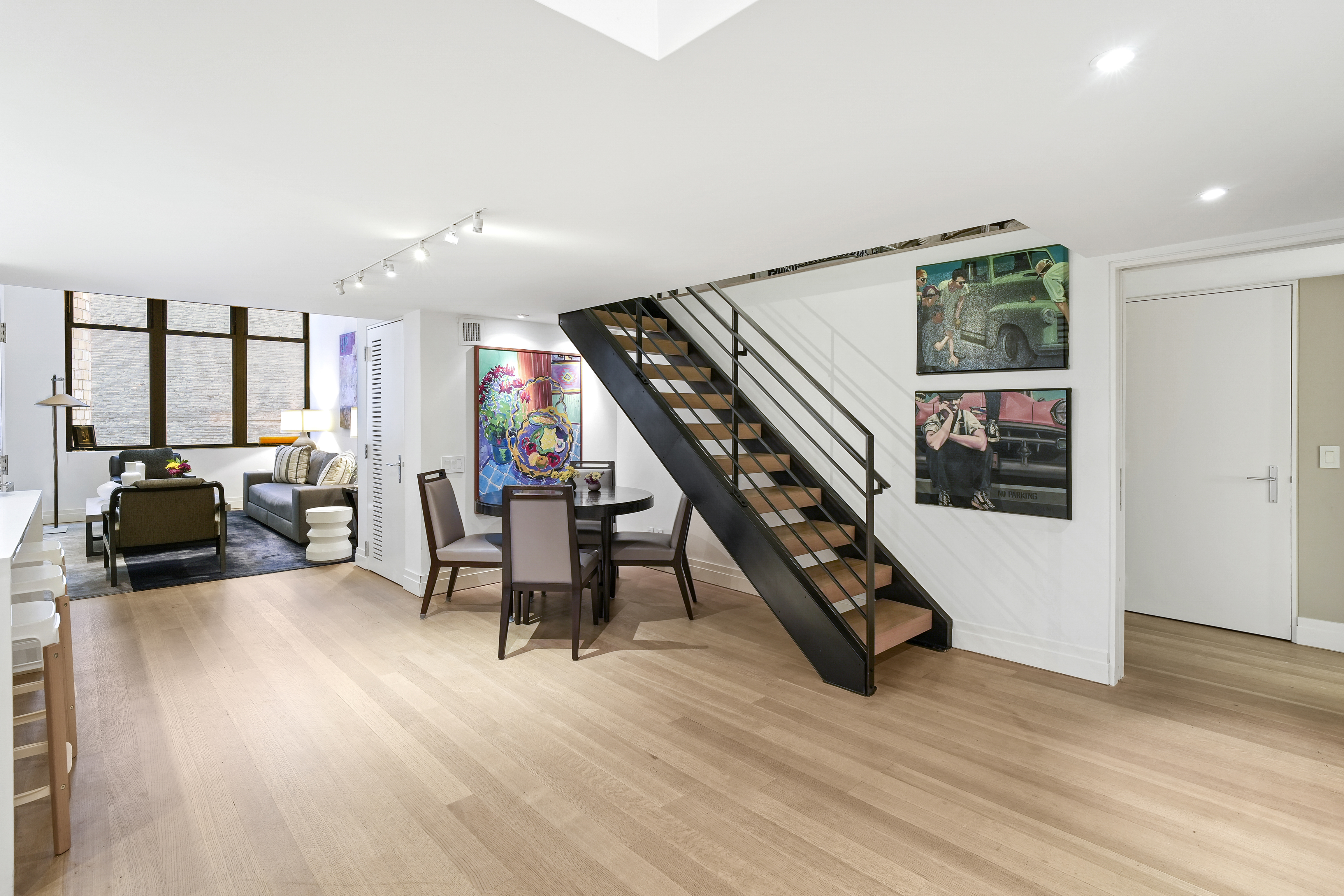 421 Hudson Street, Unit 221 Manhattan, NY 10014 - Photo 4 of 12 a living room with furniture and a wooden floor