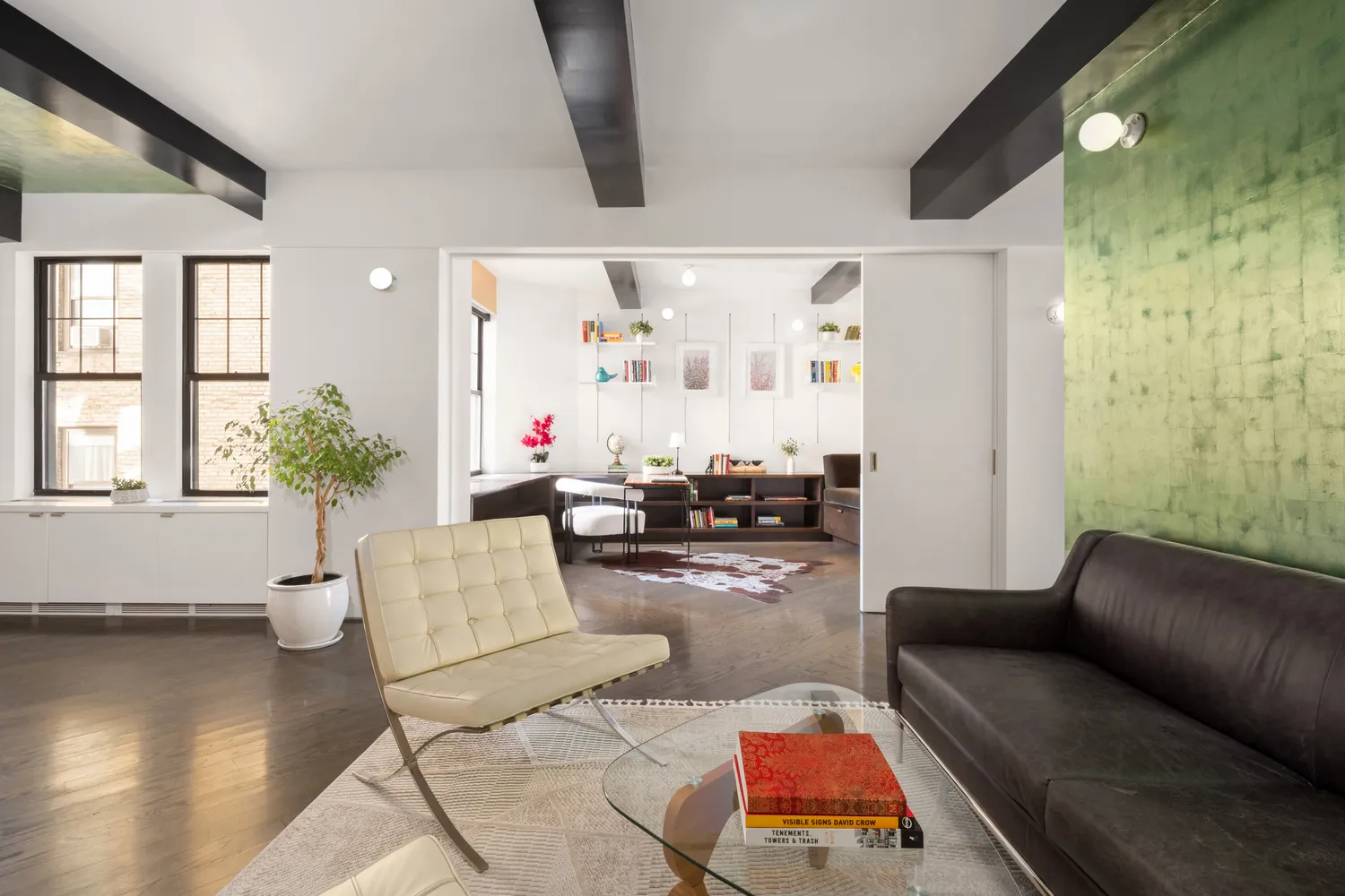 a living room with furniture and wooden floor