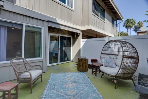 a view of a chairs in the patio of the house