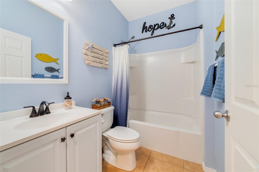 352 Giovani Boulevard Clermont, FL 34715 - Photo 17 of 46 a bathroom with a sink a toilet and shower