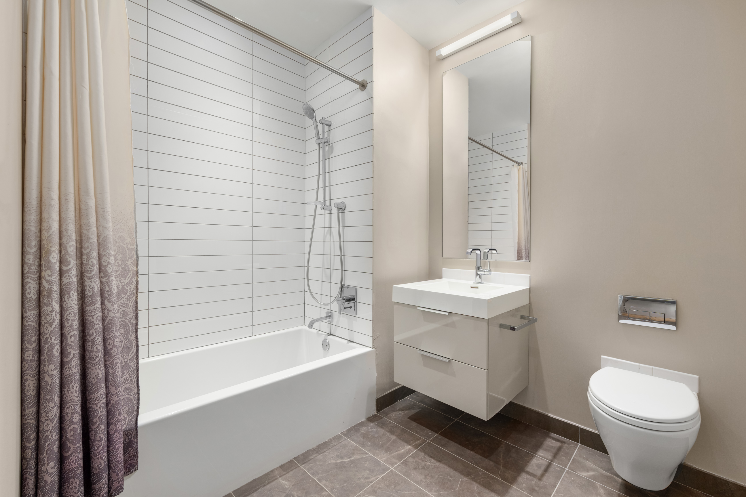 101 Leonard Street, Unit 2E Manhattan, NY 10013 - Photo 13 of 16 a bathroom with a sink toilet and bathtub