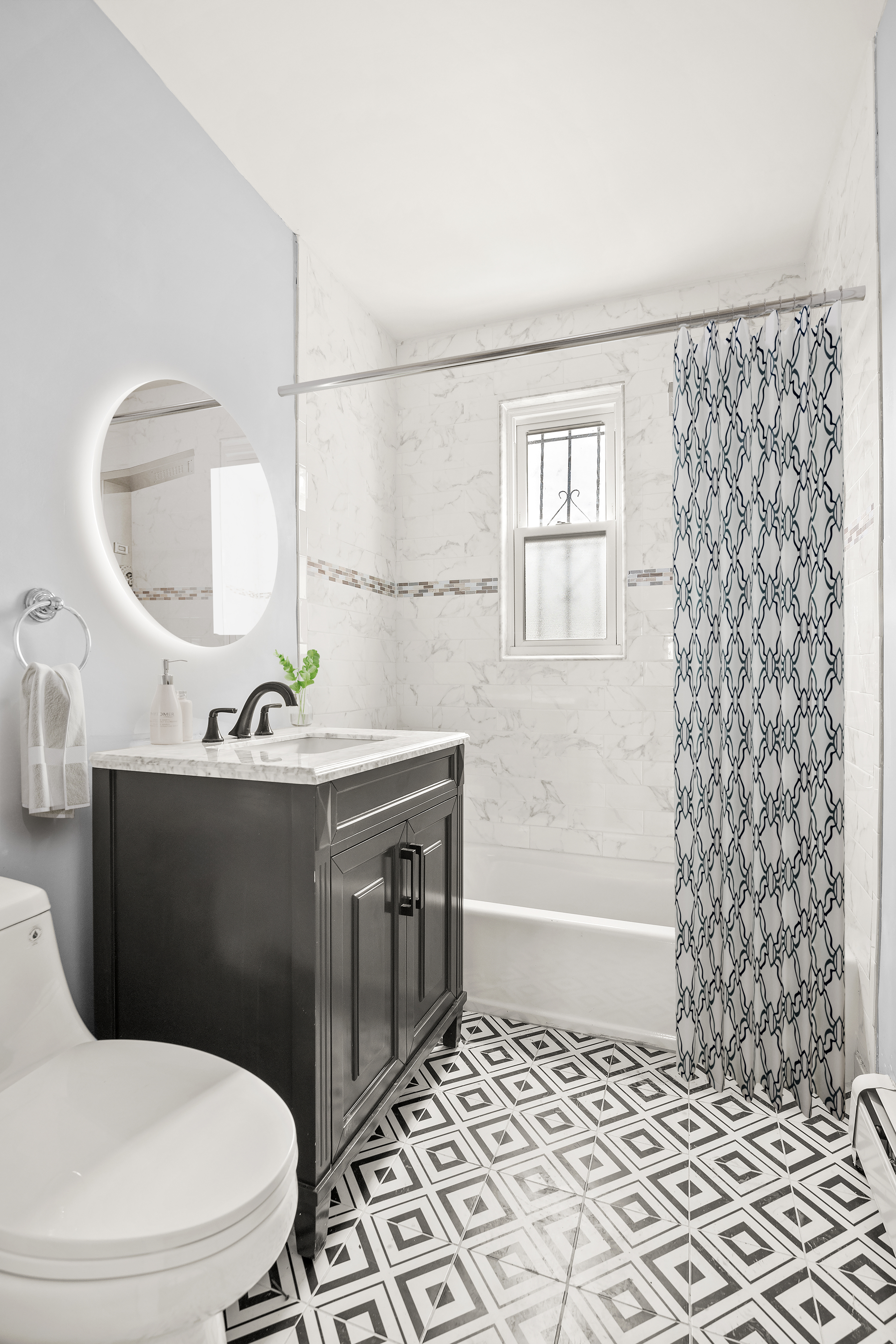 806 East 48th Street Brooklyn, NY 11203 - Photo 8 of 13 a bathroom with a sink a toilet a mirror and shower