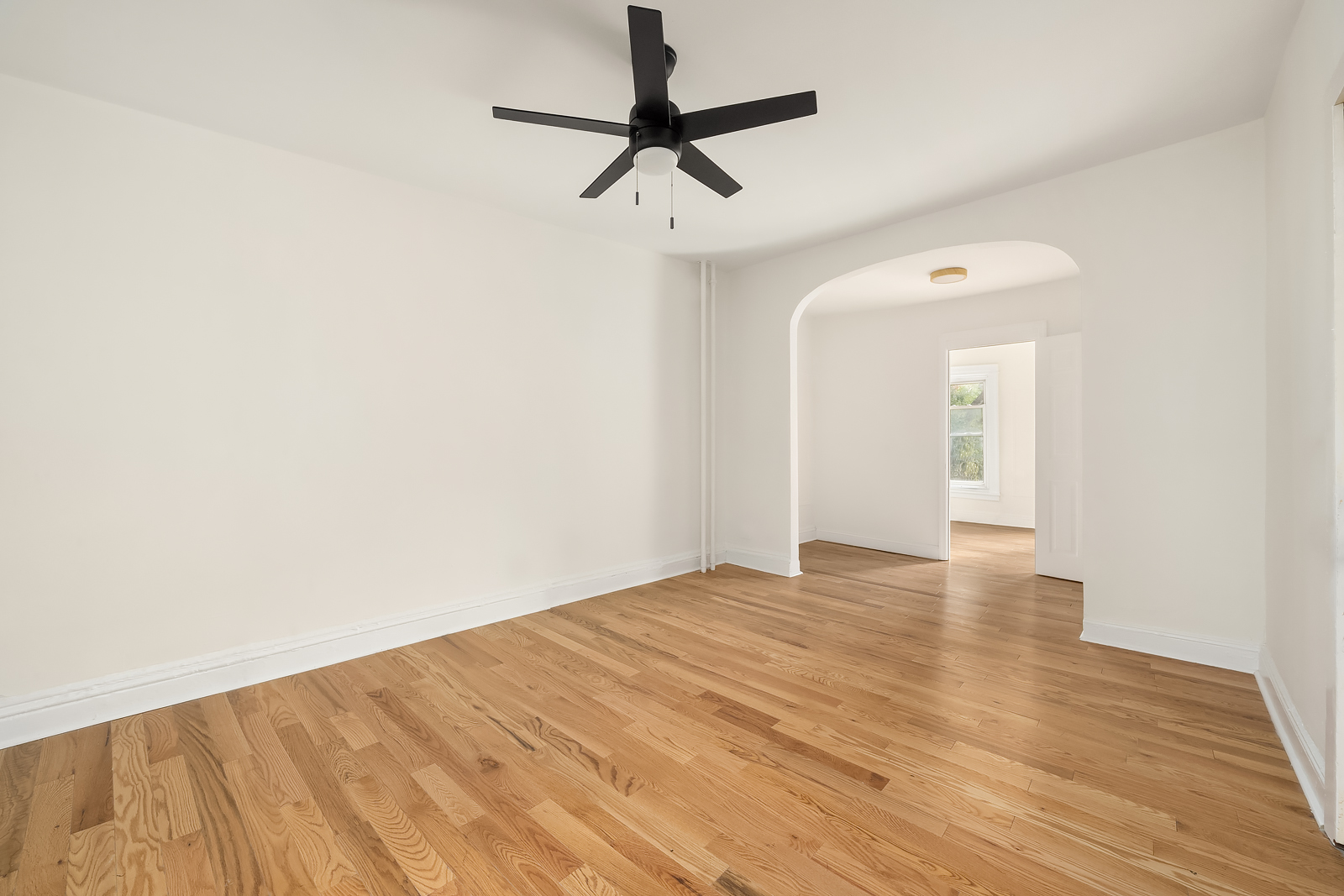 439 Union Street, Unit 3 Brooklyn, NY 11231 - Photo 3 of 9 a view of empty room with wooden floor and fan