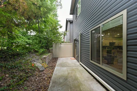 a view of a pathway both side of house