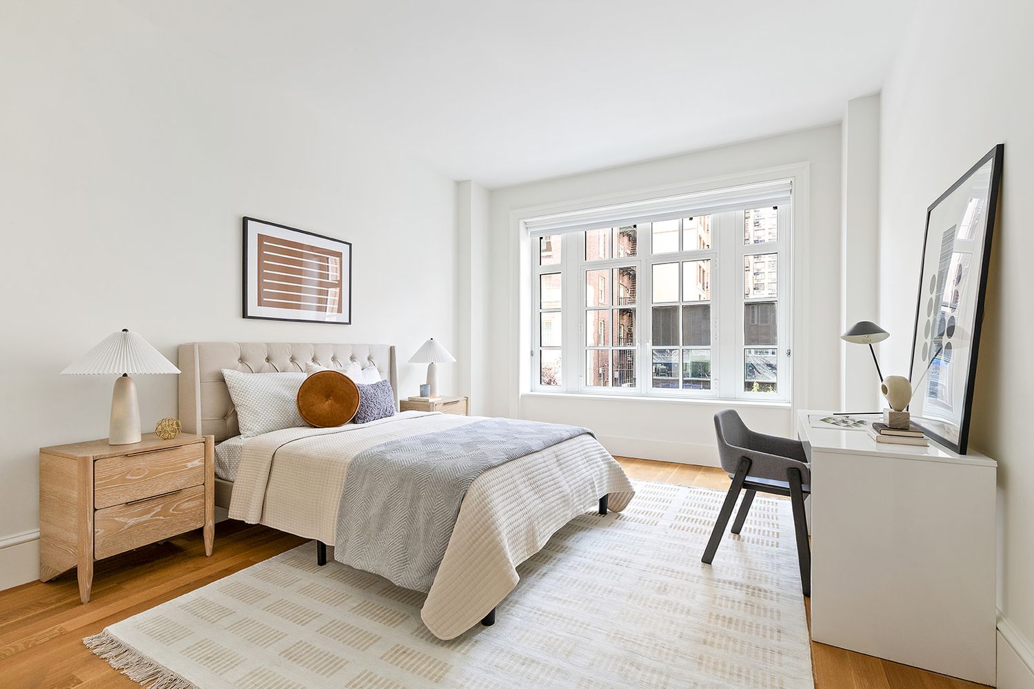 a bedroom with a bed and a large window