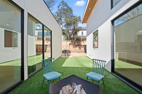 a view of a porch with furniture and a yard