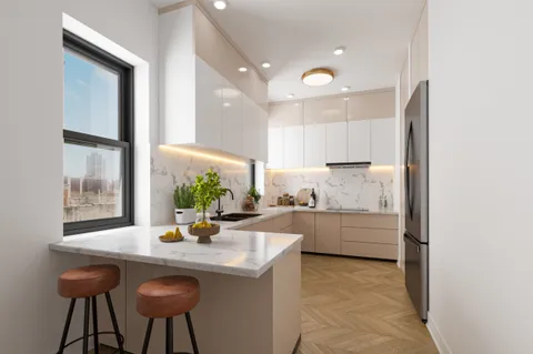 a kitchen with a sink cabinets and window