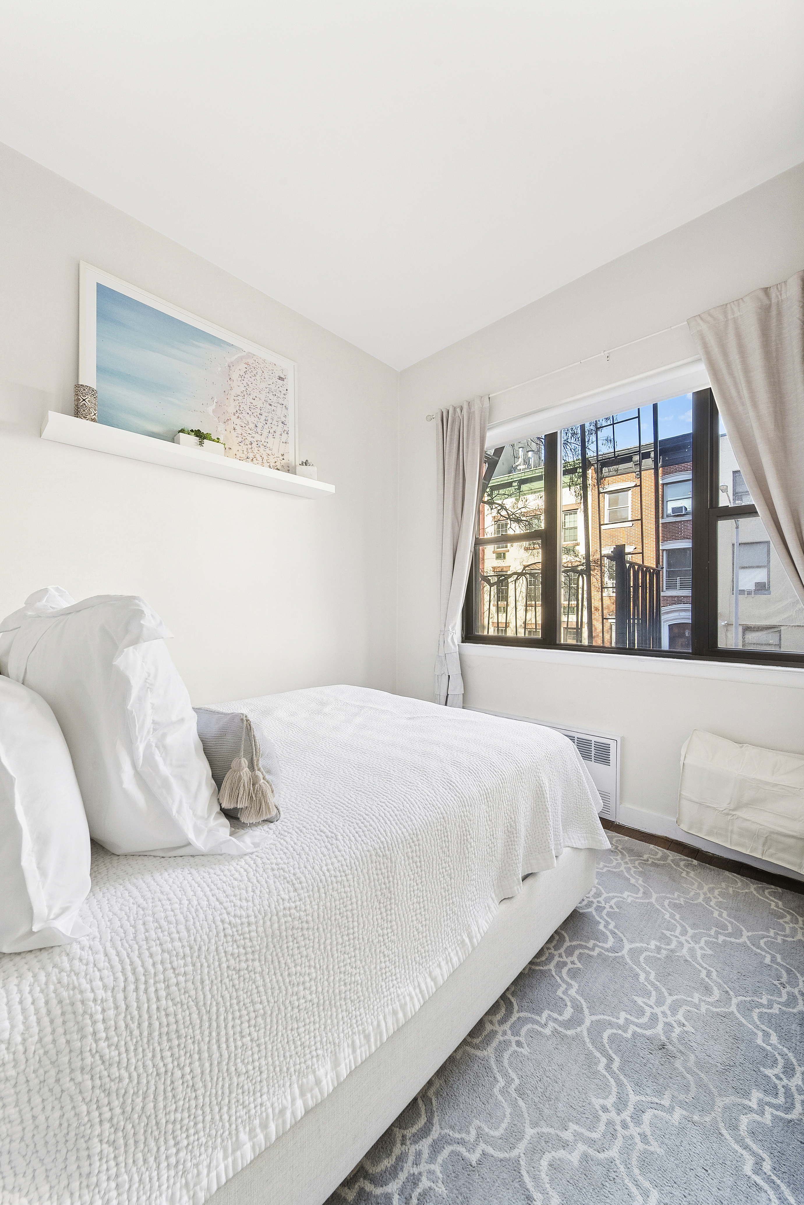 252 West 20th Street, Unit 2B Manhattan, NY 10011 - Photo 3 of 6 a bedroom with a large bed and a large window