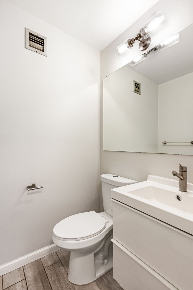 111 East 30th Street, Unit 14A Manhattan, NY 10016 - Photo 10 of 16 a bathroom with a sink a toilet and mirror