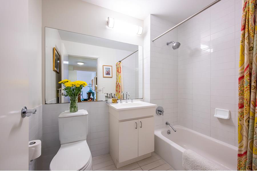 1885 Lexington Avenue, Unit 6D Manhattan, NY 10035 - Photo 6 of 7 a bathroom with a sink a toilet and shower