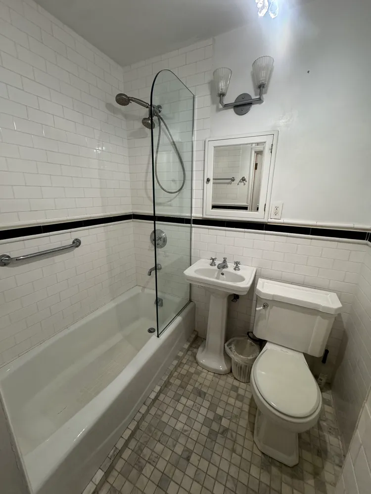 a bathroom with a toilet sink and shower