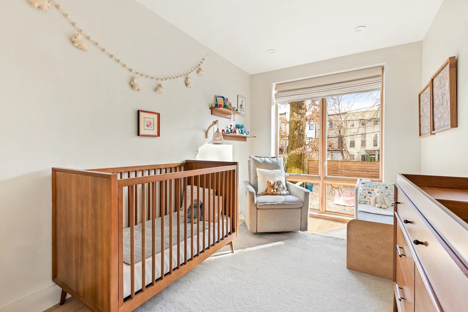a bedroom with furniture and a large window