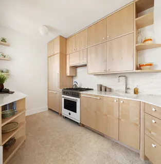 a kitchen with granite countertop a sink and cabinets