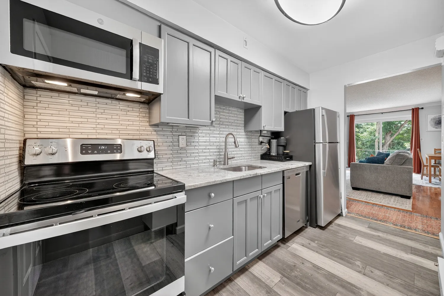 a kitchen with a refrigerator stove and microwave