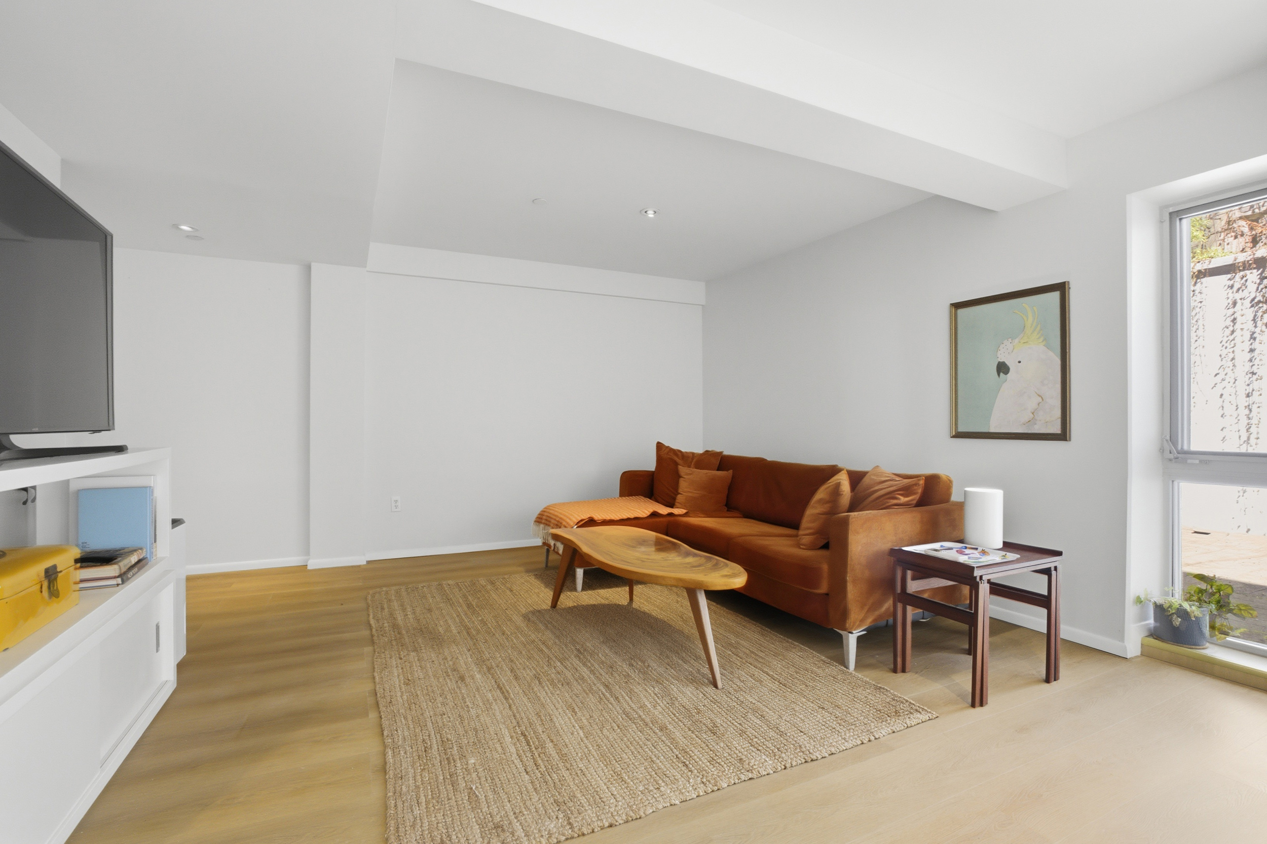 433 Warren Street, Unit 2C Brooklyn, NY 11217 - Photo 14 of 19 a living room with furniture and a flat screen tv