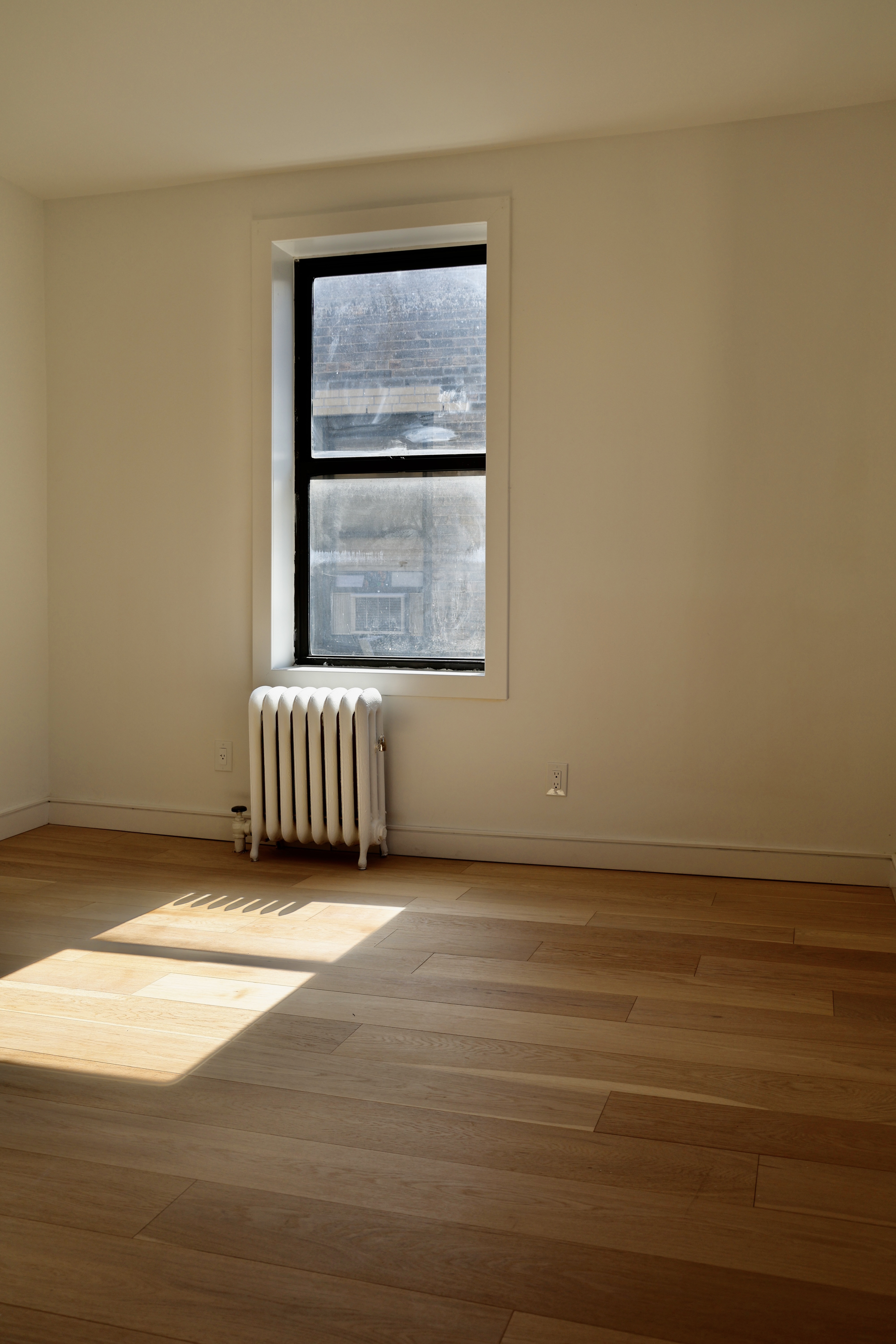 807 Riverside Drive, Unit 6E Manhattan, NY 10032 - Photo 5 of 7 a view of an empty room and window