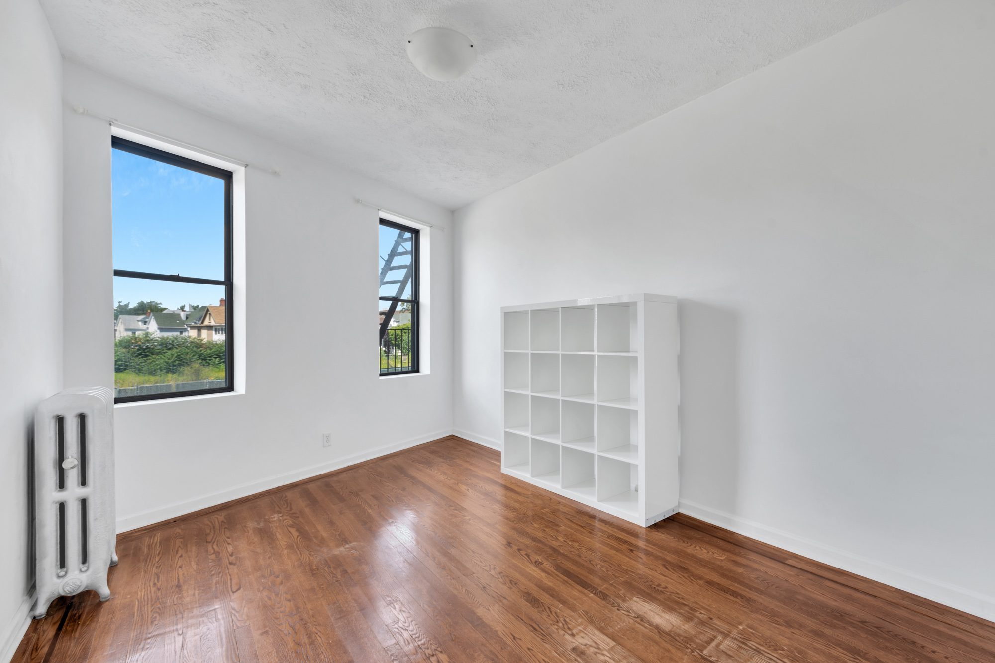 7609 4th Avenue, Unit B1 Brooklyn, NY 11209 - Photo 4 of 17 wooden floor in an empty room with a window