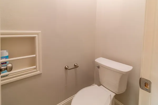 a white toilet sitting next to a shower