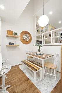 a view of a kitchen with a table and chairs in it