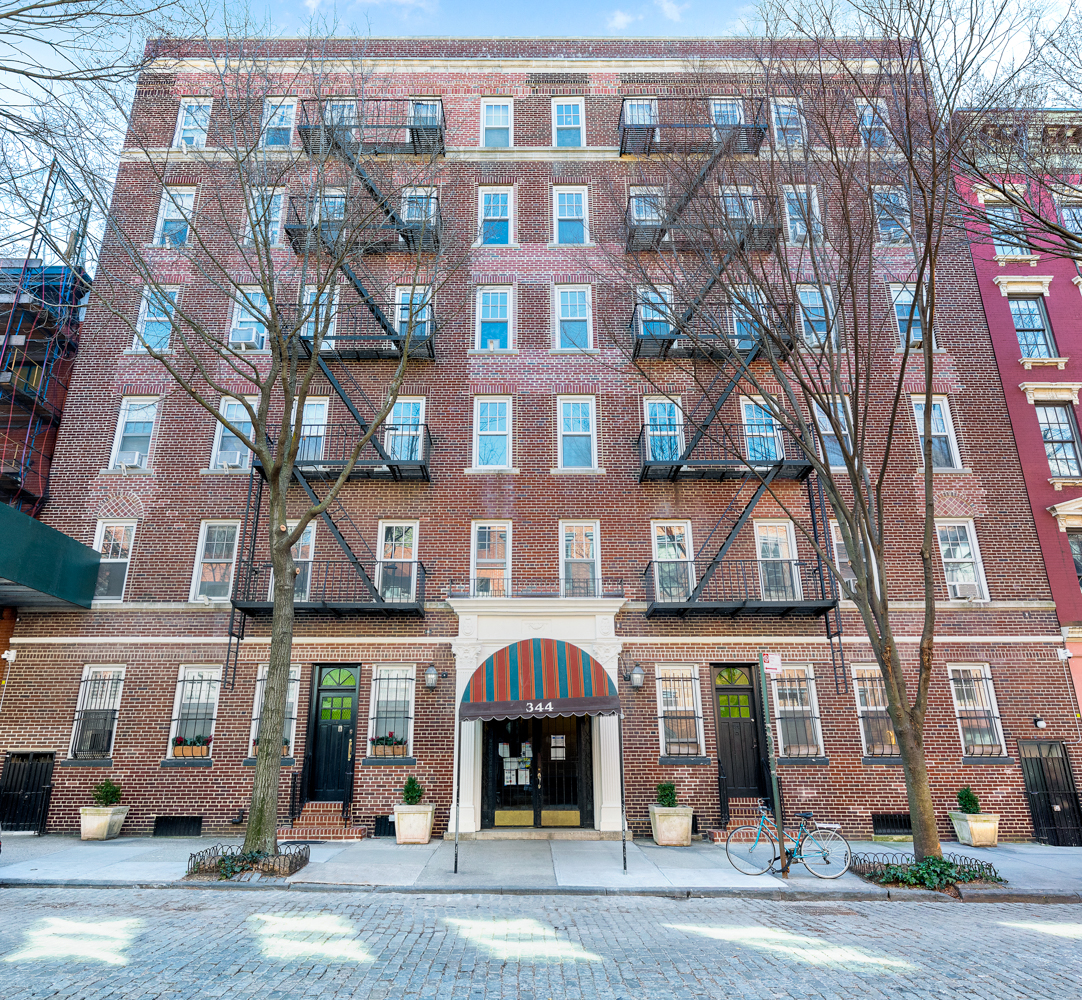 344 West 12th Street, Unit 1A Manhattan, NY 10014 - Photo 15 of 17 a front view of a building with a street