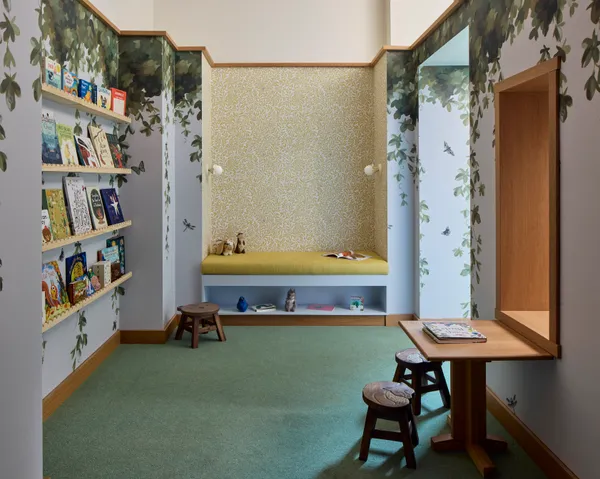 a room that has a table and a bookshelf