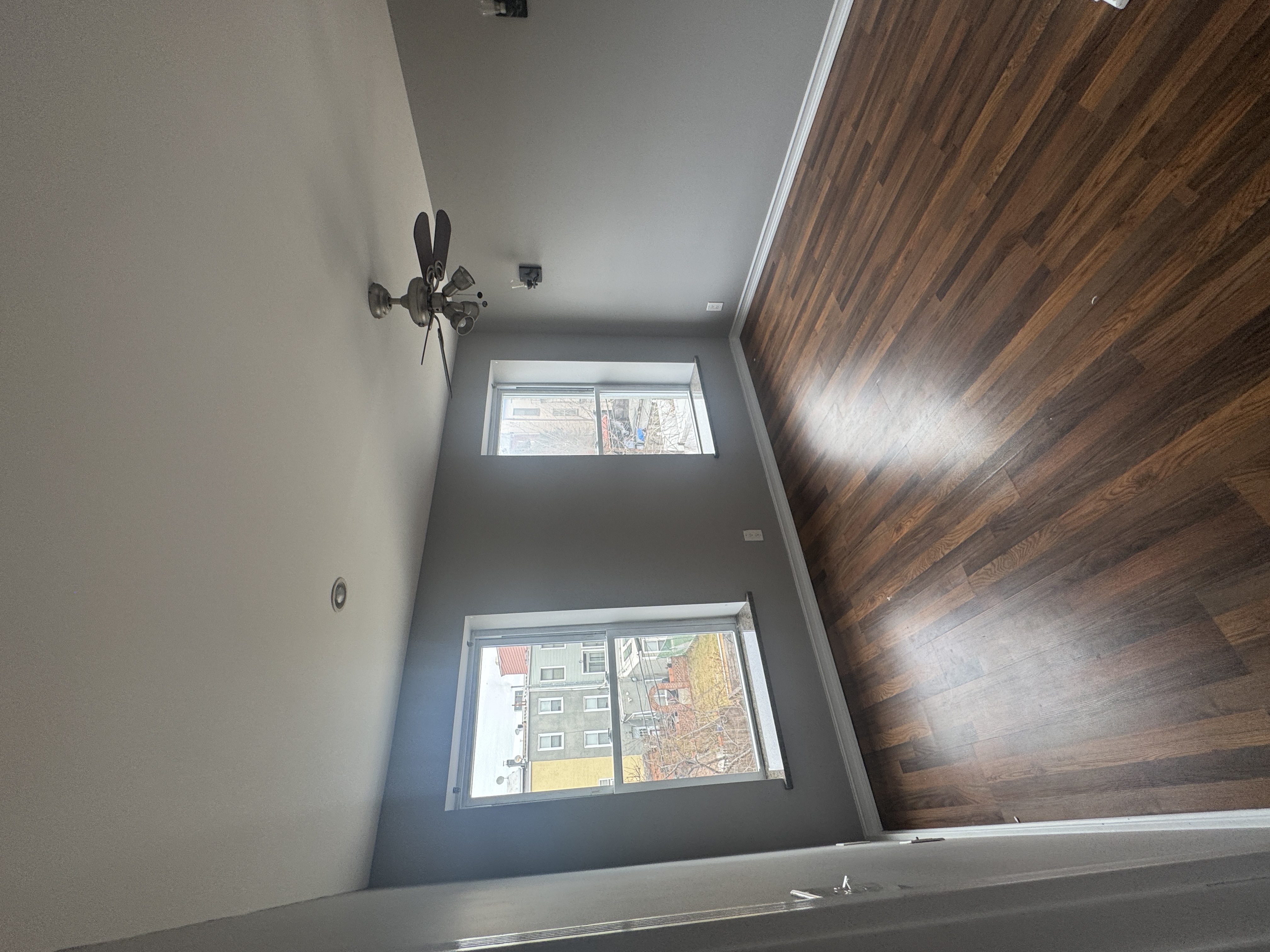193 24th Street, Unit 2 Brooklyn, NY 11232 - Photo 4 of 7 wooden floor in an empty room with a window
