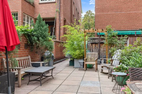 a backyard of a house with outdoor seating
